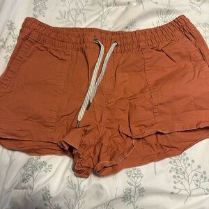 Vuori Women's Athletic Shorts in Rust